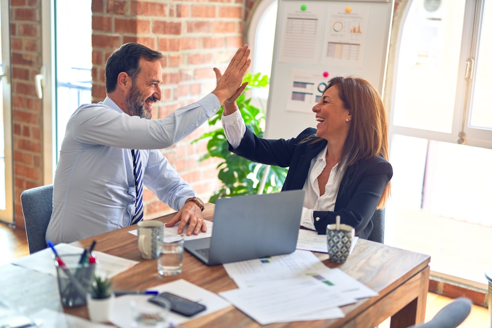Two partners celebrating a deal